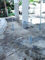 Helical piles installed with new construction brackets being placed