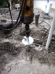 Installing helical piles around buried utilities