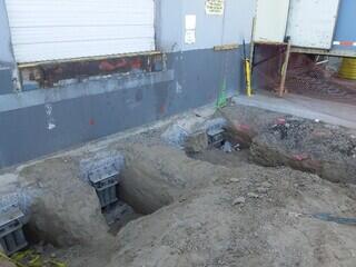 Retrofit helical piles with custom tension bracket installed