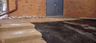 This busy entrance in Lindsay had developed a significant drop where the asphalt meets the concrete walkway. We lifted the sunken section to create a flush, seamless transition, removing the trip hazard for everyone entering the building.