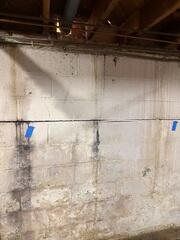 A large and concerning wall crack stretching across one of the basement walls. Our CarbonArmor wall straps stabilized the home.