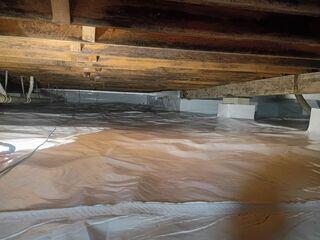 This crawl space once had a hard time at stopping moisture. A big reason why was because ground water often flooded the space. We made sure to install a proper waterproofing system underneath the vapor barrier to keep the vapor barrier protected from floods.