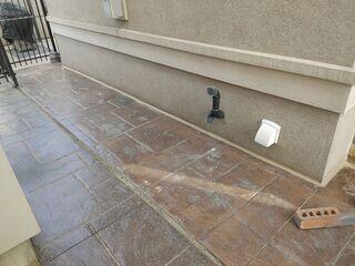 A detailed look at the side walkway following the application of our stabilizing material. This shot showcases the removal of the old, failing filler, now replaced with a smooth, watertight bead of our premium sealant along the foundation wall. It's the perfect defense against water washouts and future settling.