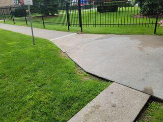 The final image captures a corner section where the concrete had significantly sunken away from the lawn and adjacent slabs. We successfully raised this area to be flush with the rest of the path, eliminating the drop-off and preventing water from pooling against the edges.
