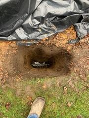 The crew in the process of installing GeoLocks. They placed the earth anchor and connected it to the interior wall