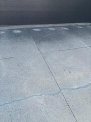 The slabs have been lifted using our polyurethane injection, closing the gap and restoring proper drainage. Trip hazard eliminated! The driveway is now flush with the garage floor and the subgrade is fully stabilized.