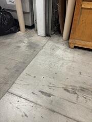 A clean 5/8" injection port drilled near the joint, allowing the polymer to stabilize the floor with minimal footprint.