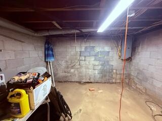 Stair-step cracks in the block foundation wall are a classic sign of settlement.