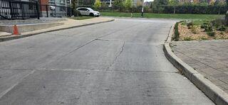 Looking back toward the street, it's clear how many cars and people rely on this space. For a busy residential complex in Toronto, having a smooth transition is vital for accessibility, especially for seniors and parents with strollers who need a reliable surface to navigate.