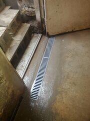 Once installed, the crew re-concretes the basement perimeter for a seamless finish,