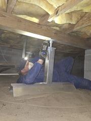 Installing SmartJacks to lift a sagging floor.