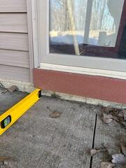 A close up of how far the slabs have sunken in front of the door