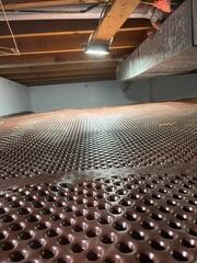 The crew added Drainage Matting along the crawl space floor