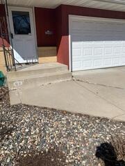 The concrete slabs at the entrance of the home began sinking causing a large step up height