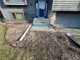 The slabs in front of the steps before our crew lifted and leveled the concrete