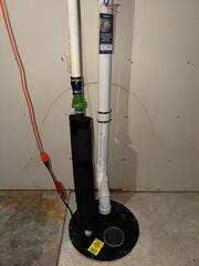 Our crew installed piping through the sump pump, connected it to the fan installed at the exterior of the home