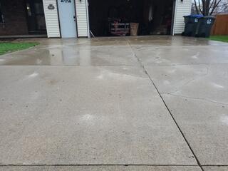Driveway lifted, leveled and repaired utilizing PolyLevel Injection Foam and NexusPro Joint Sealant to seal the cracks.