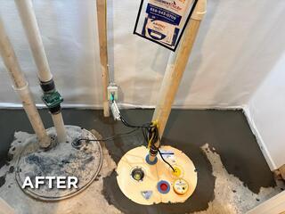 This was what the system looked like after completion. We also wrapped the front alcove room with our white CleanSpace moisture barrier to further protect the room from moisture. We also made sure to replace the discharge line outside the home to ensure the line is properly graded away from the home. This way the discharge line won't allow water to flow back down into the sump pit.