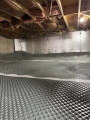 Drainage Matting System - Installed across the crawl space floor to create a separation layer and provide a more even surface