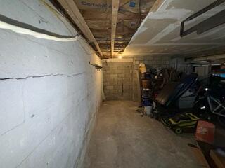 The bowed and cracked basement wall in Morgan, Vermont, will receive the support it needs to maintain the home's structural integrity.