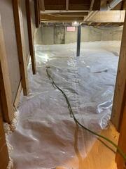 Installed a durable vapor barrier across the entire crawl space floor and along the walls. Sealed the system to help isolate the space from ground moisture