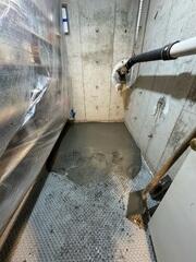 Vapor Barrier Drainage matting is laid over the old floor.