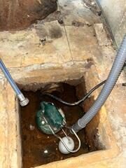 The old sump pump and poor water management system led to basement flooding.