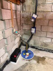 SuperSump basin and pump installed to collect and discharge water efficiently from the basement.