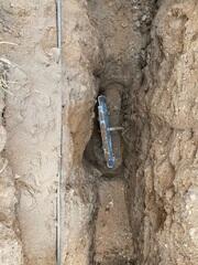 Our crew in the process on installing the earth anchor connecting it to the wall plate