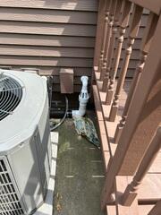 The IceGuard installed at the exterior of the home connecting to the sump pump