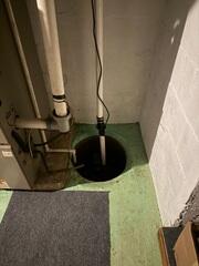 The old sump pump system was in need of an upgrade. It's also important to have a lid on the sump pump to prevent accidents and keep water from evaporating back into the basement.