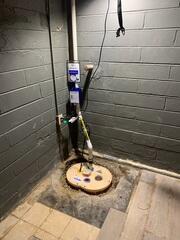 Our crew in the process of replacing the sump pump with our SuperSump+ and installing IceGuard