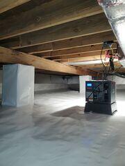 The SaniDry Sedona dehumidifier pictured here works to keep the crawl space humidity low, protecting the wooden floor joists and inhibiting mold growth.