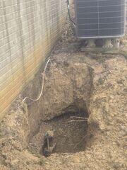 The crew is careful to install the piers around exterior appliances like this central air conditioning unit.
