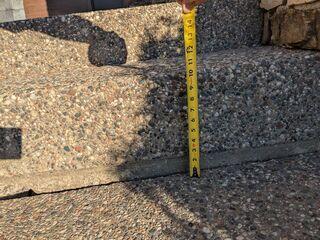 A close-up of one of the steps where the slabs have sunken over 2 inches