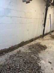 After removing the demo-d materials, the crew begins by digging a trench around the basement perimeter.