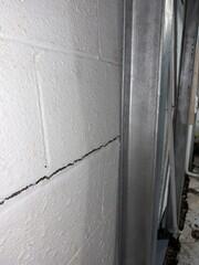 The crew installs static beams to stabilize the bowing walls.