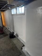 During: Our Foreman, Roel, and his crew worked hard to secure all the waterproofing products throughout the basement.