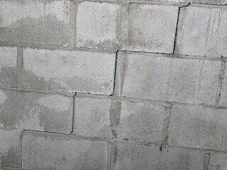 A close up of the stair step cracks that have formed along the foundation walls