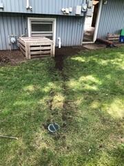 The IceGuard installed at the exterior of the home connecting to the sump system