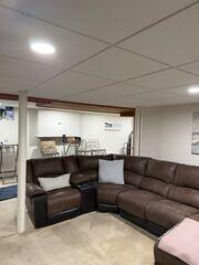 Drop ceiling installation in the main basement area.