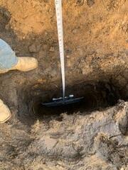 Our crew attached the earth anchor to the small steel pole that runs through the ground, connecting it to the interior wall plate