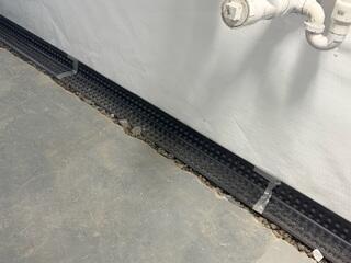 The drainage system catches wall leaks and moisture behind the CleanSpace vapor barrier.
