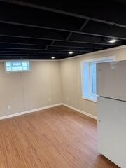 This newly finished basement showcases a clean, bright, and inviting space designed for everyday living. With updated walls, flooring, and ceiling finishes, the transformation provides the homeowner with a comfortable extension of their home that is both functional and welcoming.
