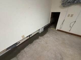 The crew re-concretes the floor. Once dry, the walls and floors can be safely re-finished.