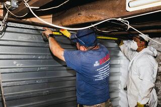 Our crew working to install engineered steel reinforcement for long-term structural stabilization.