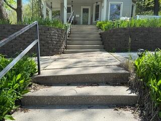 Before: Our Design Specialist, Romeo, recommended securing PolyLevel below the uneven, damaged stairs.