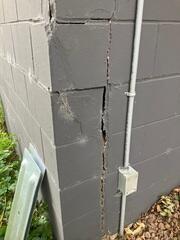 A close up of the cracking on the block foundation