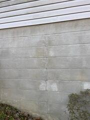 A vertical crack in a block foundation wall such as this one typically indicates outward movement.