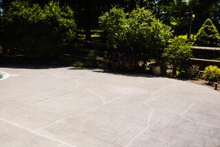 The finished project improved the look and usability of the pool area while helping the homeowner avoid the disruption of a full concrete replacement.